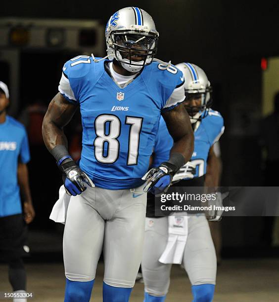 Receiver Calvin Calvin Johnson of the Detroit Lions jogs on the field before a game with the Cleveland Browns at Ford Field in Detroit, Michigan. The...