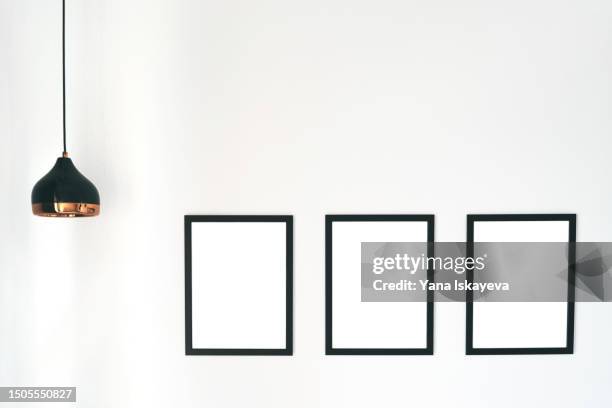 a wall with three white isolated blank frames, easy to put custom design - triptych stock pictures, royalty-free photos & images