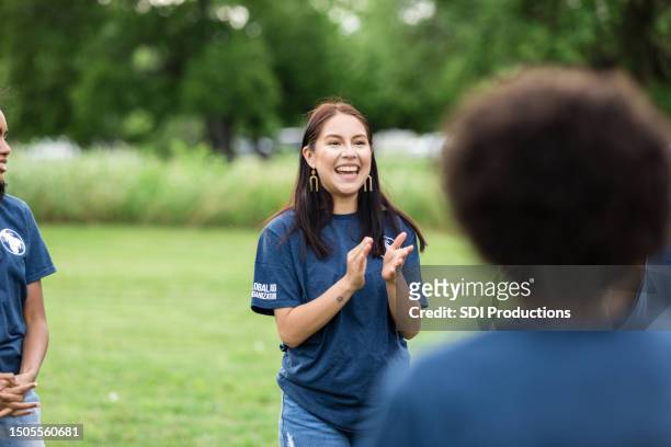 young adult female smiles and cheers for the unseen team member - ohio nature stock pictures, royalty-free photos & images