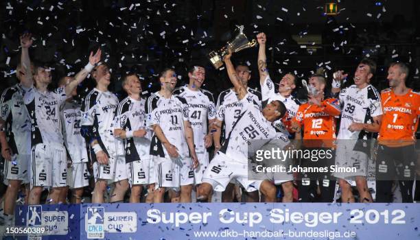 The team of Kiel celebrates after winning the Handball Supercup match between THW Kiel and SG Flensburg Handewitt at Olympia Eishalle on August 21,...
