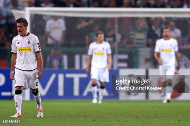 Patrick Herrmann, Tony Jantschke and Martin Stranzl of Moenchengladbach look dejected after the third goal of Kiew during the UEFA Champions League...