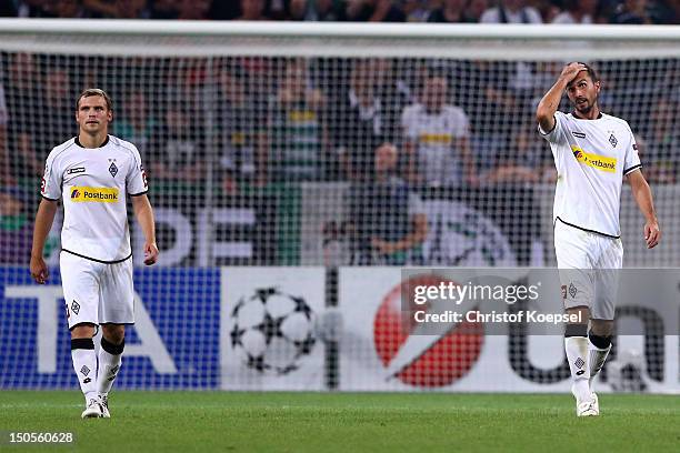 Tony Jantschke and Martin Stranzl of Moenchengladbach look dejected after the third goal of Kiew during the UEFA Champions League play-off first leg...