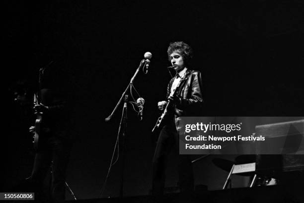 Folk singer Bob Dylan goes electric at the Newport Folk Festival on July 25, 1965 in Newport, Rhode Island.