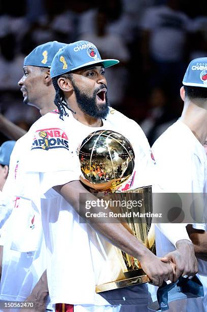 Ronny Turiaf of the Miami Heat celebrates with the Larry O'Brien Finals Championship trophy after they won 121-106 against the Oklahoma City Thunder...