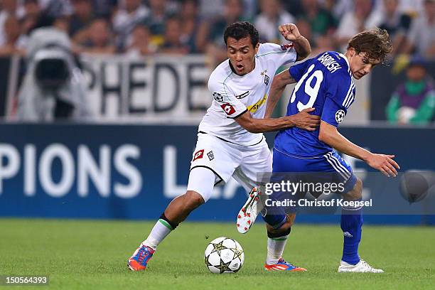 Denys Garmash of Kiew challenges Juan Arrango of Moenchengladbach during the UEFA Champions League play-off first leg match between Borussia...