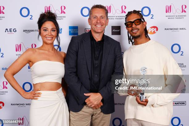 Tulisa Contostavlos, a representative from ASM Global and Fazer with the Best Group Award for N-Dubz pose in the winners room with the award for...