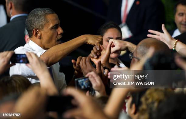 President Barack Obama fist bumps with supporters after delivering remarks during a campaign event at Truckee Meadows Community College in Reno,...