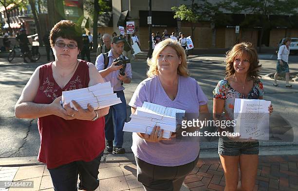 Bonnie Borman , Cheryl Randecker and Pamela Lampros deliver a petition with more than 35,000 signatures to the offices of Bain Capital urging the...