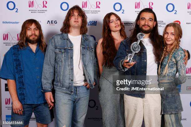 Ellis Durand, Henry Holmes, Rhian Teasdale, Joshua Mobaraki and Hester Chambers of Wet Leg pose in the winners room with the New Music Award during...
