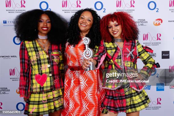 Amy Love, Kanya King and Georgia South of Nova Twins pose in the winners room with the Innovation Award during the Nordoff and Robbins O2 Silver Clef...