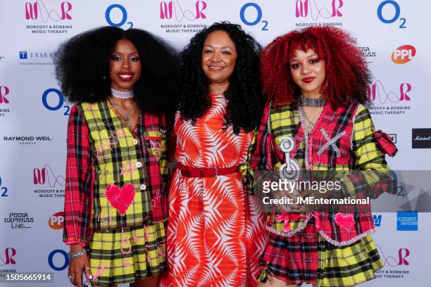Amy Love, Kanya King and Georgia South of Nova Twins pose in the winners room with the Innovation Award during the Nordoff and Robbins O2 Silver Clef...
