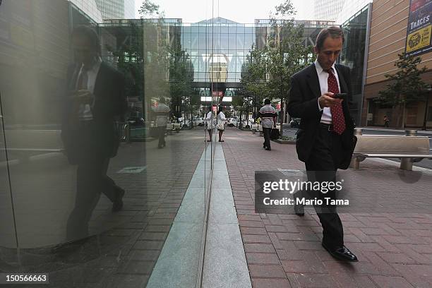 Businessman walks down a sidewalk on August 21, 2012 in North Carolina. Businesses and attractions in Charlotte are anticipating a boost in visitors...