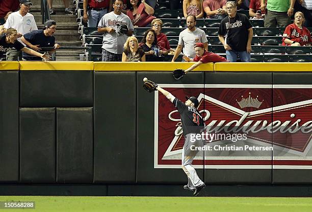 Outfielder Bryan Petersen of the Miami Marlins makes a running catch against the wall on a fly ball hit by Jacob Elmore during the fourth inning of...