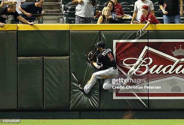 Outfielder Bryan Petersen of the Miami Marlins makes a running catch against the wall on a fly ball hit by Jacob Elmore during the fourth inning of...