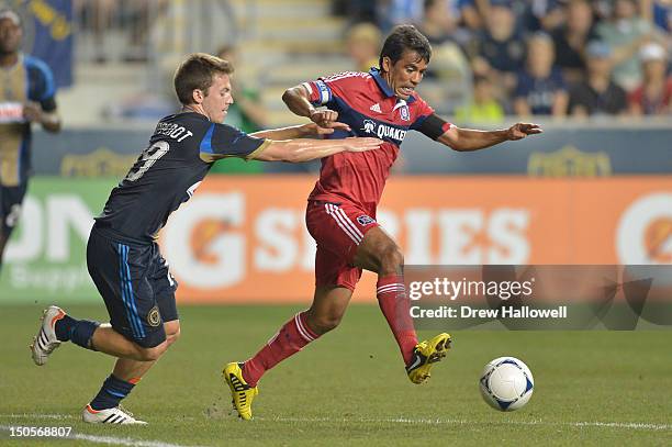 Pavel Pardo of the Chicago Fire is grabbed by Antoine Hoppenot of the Philadelphia Union at PPL Park on August 12, 2012 in Chester, Pennsylvania. The...