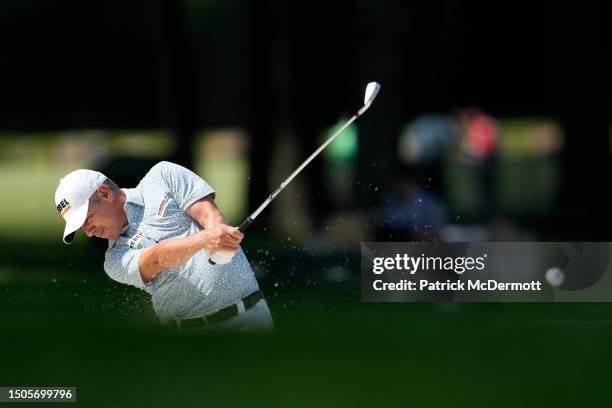 Adilson da Silva of Brazil hits from a bunker on the 18th hole during the second round of the U.S. Senior Open Championship at SentryWorld on June...