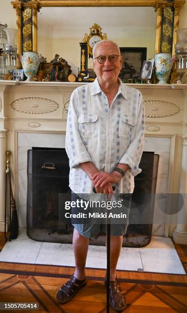 Portrait of American film director James Ivory as he poses in front of a fireplace in his home, Claverack, New York, June 23, 2023.