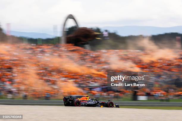 Max Verstappen of the Netherlands driving the Oracle Red Bull Racing RB19 passes a grandstand filled with fans during qualifying ahead of the F1...