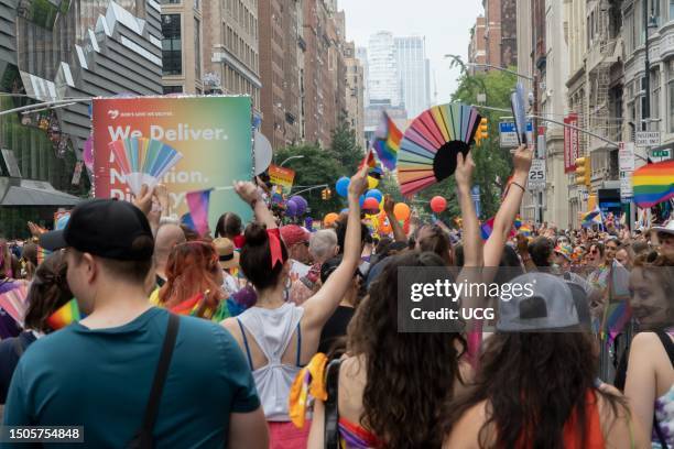 Participants and spectators are jam-packed on 5th Avenue, between 14th and 13th Streets, in Manhattan, during NYC Pride March 2023. Marchers hold and...