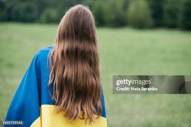 ukrainian child girl in embroidered shirt vyshyvanka with yellow and blue flag of ukraine in garden - maidan nezalezhnosti stock pictures, royalty-free photos & images