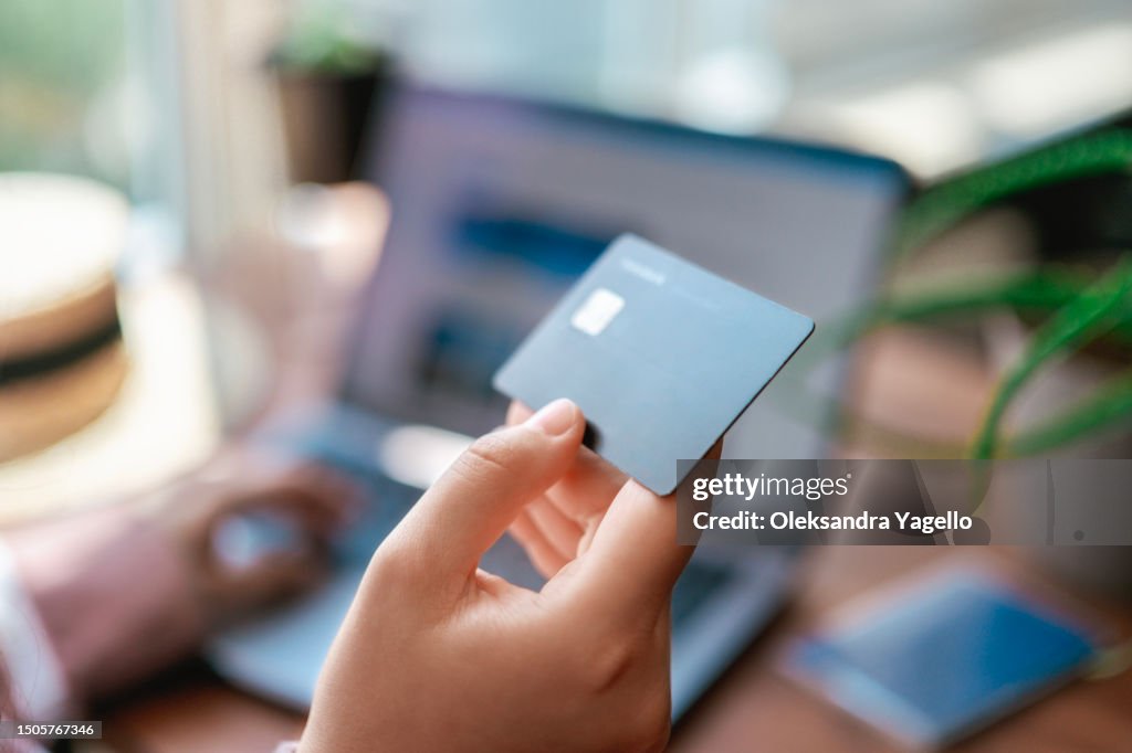 Business trip planning. Credit card in hand close up