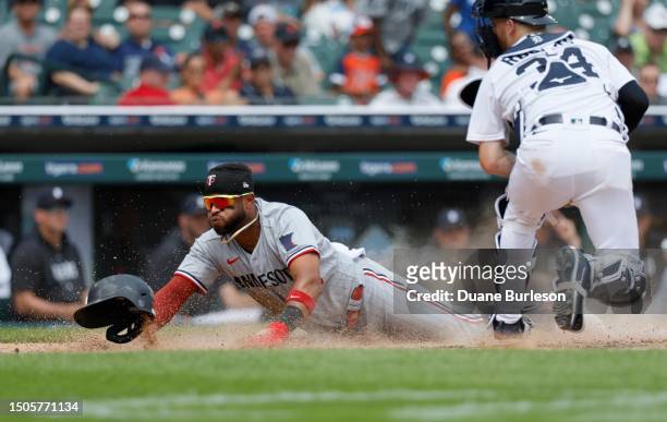 Willi Castro of the Minnesota Twins scores past catcher Jake Rogers of the Detroit Tigers during the 10th inning at Comerica Park on June 25, 2023 in...