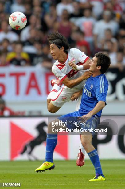 Shinji Okazaki of Stuttgart and Artur Yusupov of Moscow battle for the ball during the UEFA Europa League Qualifying Play-Off match between VfB...