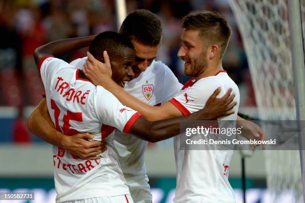 Vedad Ibisevic of Stuttgart celebrates with teammates Ibrahima Traore and Tunay Torun after scoring his team's second goal during the UEFA Europa...