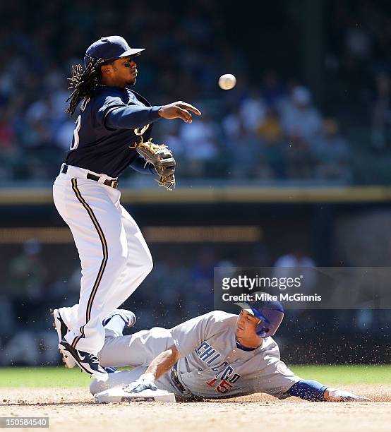 Rickie Weeks of the Milwaukee Brewers jumps over Darwin Barney of the Chicago Cubs while turning the double play at second base during the top of the...