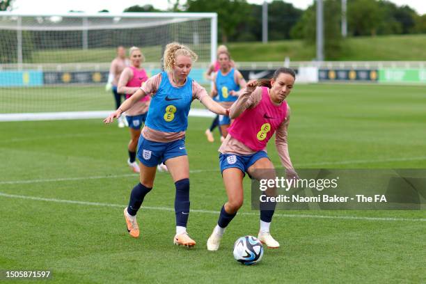 Katie Robinson and Lucy Staniforth of England battle for possession during a training session at St George's Park on June 30, 2023 in Burton upon...