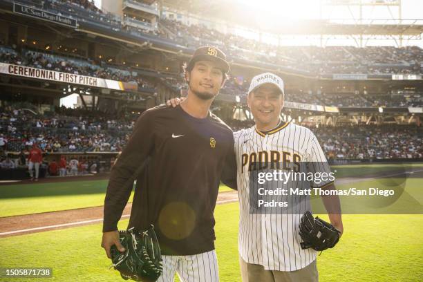 Actor Ken Watanabe poses for a photo with Yu Darvish of the San Diego Padres after throwing out the ceremonial first pitch before the game between...