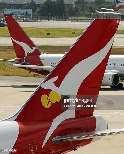 In a picture taken on August 22 a boxing kangaroo design is displayed on the tail of a Qantas plane at the Sydney International Airport. Australian...
