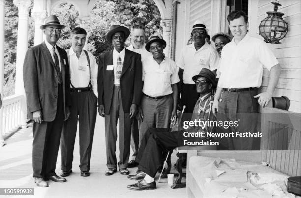 Folk and blues greats pose for a portrait in July, 1964 at the Newport Folk Festival in Newport, Rhode Island. L-R: guitarist and singer Reverend...