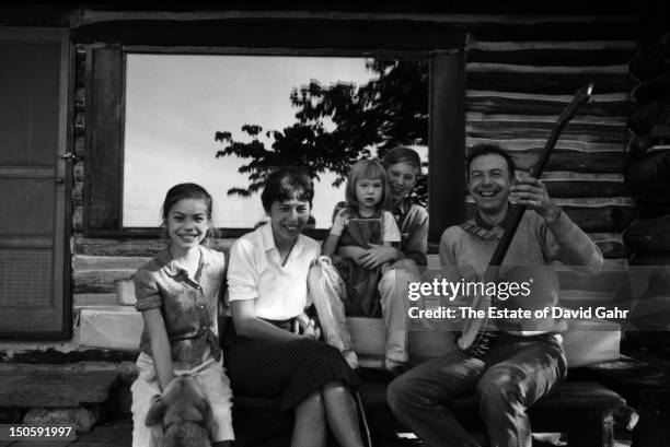 Folk musician Pete Seeger poses for a portrait with his family at their log cabin home in August, 1958 in Beacon, New York.