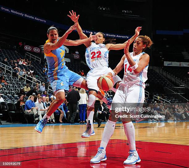 Ticha Penicheiro of the Chicago Sky drives to the basket against Armintie Price and Erika deSouza of the Atlanta Dream at Philips Arena on August 22,...