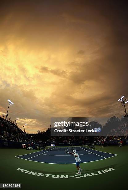 Jurgen Melzer of Austria warms up before his match against John Isner of the USA during the third round of the Winston-Salem Open at Wake Forest...