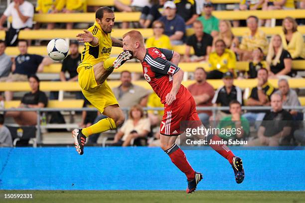 Richard Eckersley of Toronto FC is kicked in the face by Federico Higuain of the Columbus Crew as he heads the ball away in the first half on August...