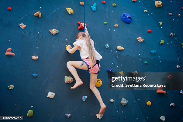 child girl climbing the climbing wall - kids rope climb stock pictures, royalty-free photos & images