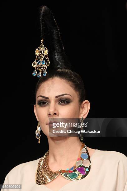 Model walks the runway in a Aavriti Jain - Daspan Jewellery design at the India International Jewellery Week 2012 Day 4 at the Grand Hyatt on August...