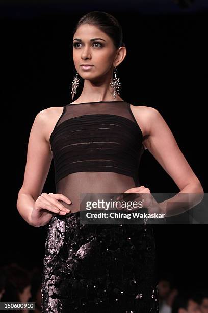 Model walks the runway in a Manish Khattar Jewellery design at the India International Jewellery Week 2012 Day 4 at the Grand Hyatt on August 22,...