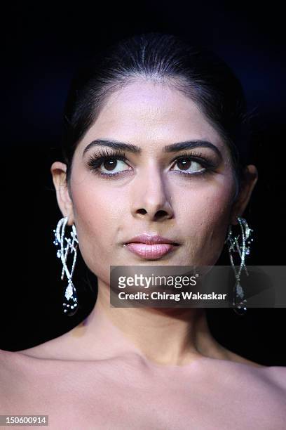 Model walks the runway in a Manish Khattar Jewellery design at the India International Jewellery Week 2012 Day 4 at the Grand Hyatt on August 22,...