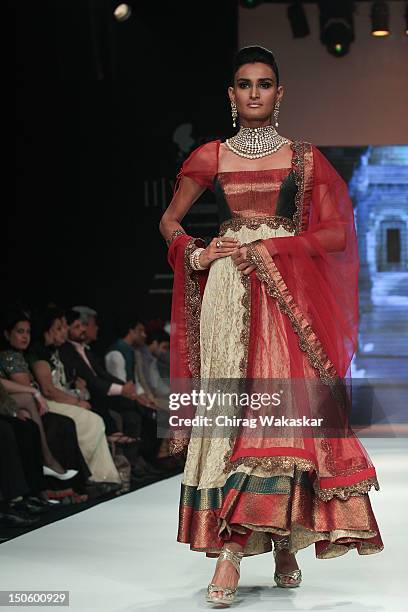 Model walks the runway in a Saboo Fine Jewels Jewellery design at the India International Jewellery Week 2012 Day 4 at the Grand Hyatt on August 22,...