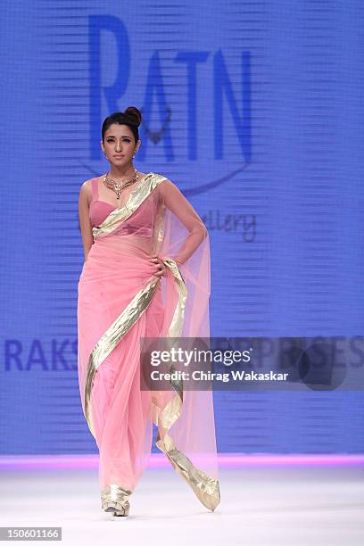 Model walks the runway in a Raksha Entp Jewellery design at the India International Jewellery Week 2012 Day 4 at the Grand Hyatt on August 22, 2012...