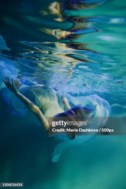 woman swimming in sea,moscow,russia - zeemeermin stockfoto's en -beelden