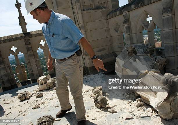 Chief stonemason Joe Alonso examines the damage to the "Gloria in Excelsis" tower of the Washington National Cathedral a day after a 5.8 magnitude...