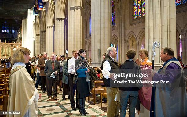 Long line forms at the National Cathedral to greet the new Episocal Bishop, Mariann Budde, second from right after services Sunday, November 13, 2011...