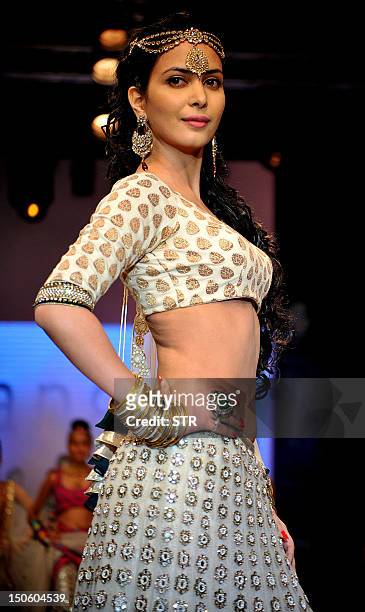 Indian Bollywood film actress Ankita Shorey showcases jewellery designer Gitanjali Jewels creations as she walks the ramp during the fourth day of...