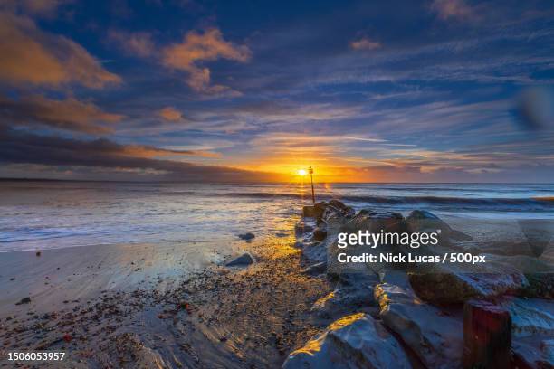 scenic view of sea against sky during sunset,christchurch,united kingdom,uk - christchurch stock pictures, royalty-free photos & images