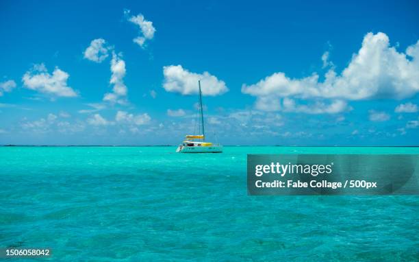 scenic view of sea against sky,french polynesia - blue sailboat stock pictures, royalty-free photos & images