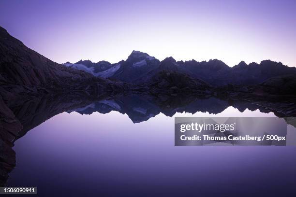 scenic view of lake and mountains against clear blue sky,wallis,switzerland - kanton wallis stock-fotos und bilder